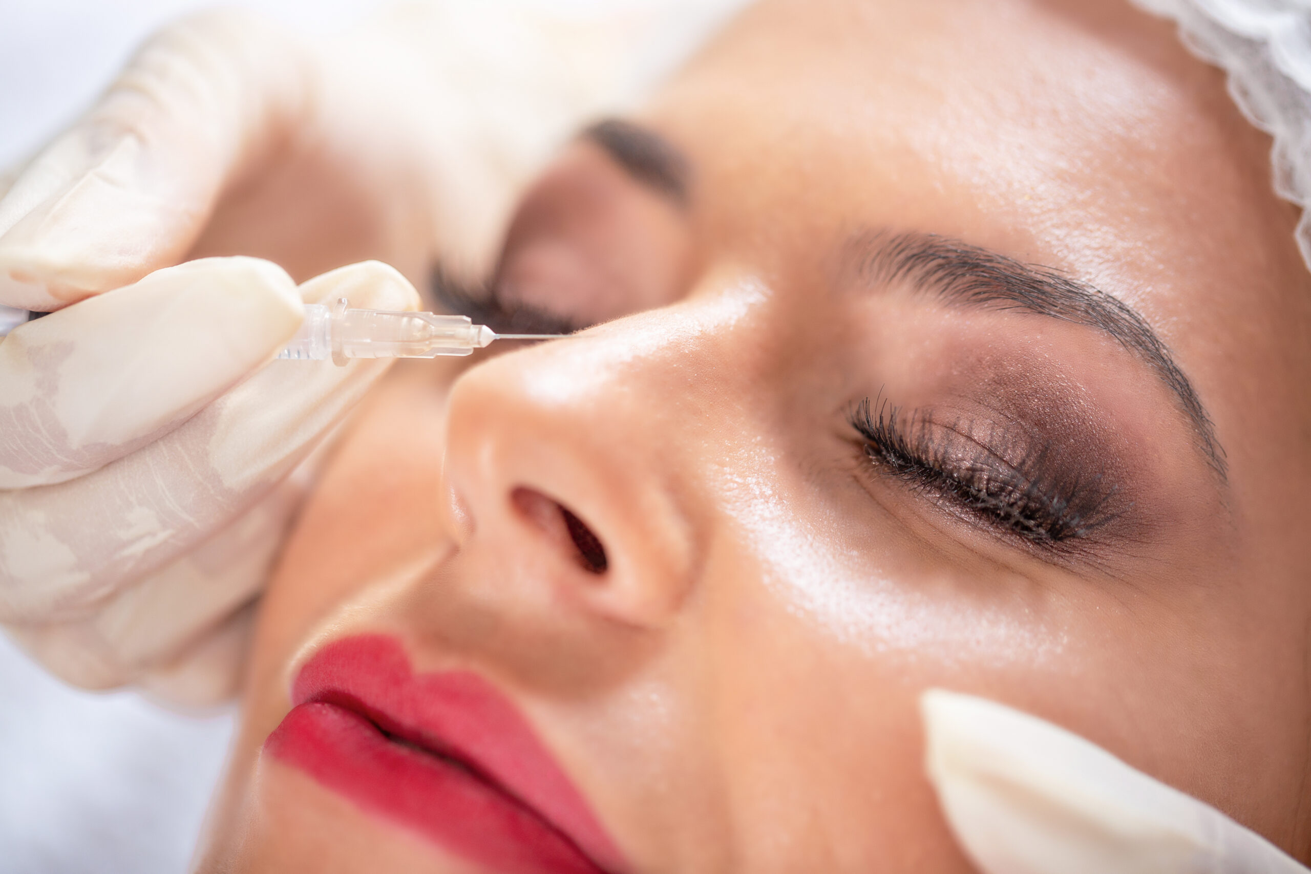 Pretty lady having a cosmetics treatment on her nose